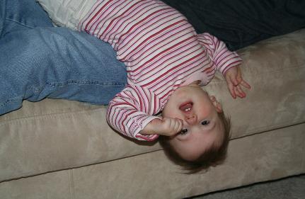 Hanging upside down from the couch.  It seems to me that Laura also has some pictures like this, too.
