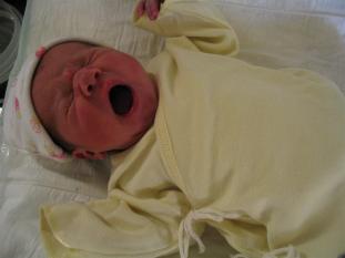 On the changing table.  The shirt is typical for newborns in this country.  Our friend's say it looks like a Jedi.