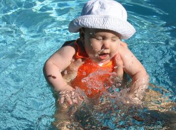 In the neighbor's pool. Audj loves splashing in the water, and this picture caught droplets.